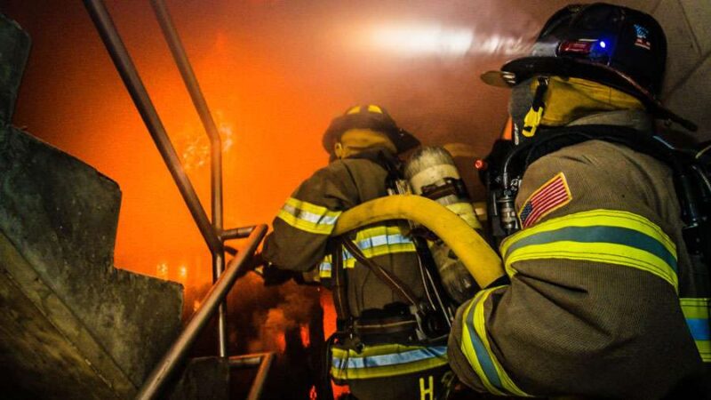 Firefighter Finesss Equipment - Amercian Firefighters climbing stairs to fight fire